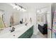 Bathroom featuring a double sink vanity with modern lighting and a doorway leading to a bedroom at 102 Stargaze Rdg, Canton, GA 30114