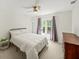 Neutral bedroom with a ceiling fan and large window with curtains to let in the daylight at 102 Stargaze Rdg, Canton, GA 30114