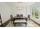 Bright dining room featuring hardwood floors, a modern chandelier, and a large window at 102 Stargaze Rdg, Canton, GA 30114