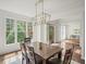 Bright dining room with hardwood floors and a window that offers an open view to the front yard at 102 Stargaze Rdg, Canton, GA 30114