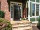 Inviting front entryway with stone steps, a decorative goose, and a dark-stained wooden front door at 102 Stargaze Rdg, Canton, GA 30114