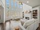 Spacious living room with tall windows, fireplace, and hardwood floors at 102 Stargaze Rdg, Canton, GA 30114