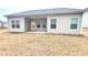 Back of the house with a covered patio and a spacious backyard at 1125 Campbell Pine Trl, Lawrenceville, GA 30045