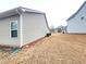 A view of the backyard with side of home showing, and other homes in the distance at 1125 Campbell Pine Trl, Lawrenceville, GA 30045