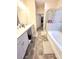 Spacious bathroom with double vanity, a large tub, and neutral flooring at 1125 Campbell Pine Trl, Lawrenceville, GA 30045