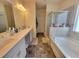 The bathroom features a separate shower and bathtub at 1125 Campbell Pine Trl, Lawrenceville, GA 30045