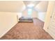 Bright, carpeted bedroom with slanted ceilings, and a window providing natural light at 1125 Campbell Pine Trl, Lawrenceville, GA 30045