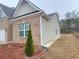 Brick and light siding detailing with gutter and landscaping of the property exterior at 1125 Campbell Pine Trl, Lawrenceville, GA 30045