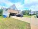 Exterior view showcasing driveway, garage, and landscaping in a well-maintained yard at 1125 Campbell Pine Trl, Lawrenceville, GA 30045