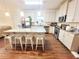 Well-appointed kitchen features white cabinets, a large island with seating, and stainless steel appliances at 1125 Campbell Pine Trl, Lawrenceville, GA 30045