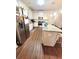 Well-equipped kitchen with a stainless steel refrigerator and granite countertop island with seating at 1125 Campbell Pine Trl, Lawrenceville, GA 30045