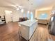 Open kitchen features a granite island, stainless steel appliances, and an adjoining dining area at 1125 Campbell Pine Trl, Lawrenceville, GA 30045