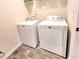 Laundry room with washer and dryer ready for use with tile flooring at 1125 Campbell Pine Trl, Lawrenceville, GA 30045
