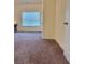 Bright living room features a large window and plush carpet at 1125 Campbell Pine Trl, Lawrenceville, GA 30045