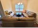 Cozy sitting area with a large leather sectional, modern decor, and a bright window at 1125 Campbell Pine Trl, Lawrenceville, GA 30045