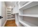 Walk-in closet with white shelves and hardwood floors at 1842 Calloway Nw Dr, Atlanta, GA 30314