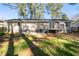 A spacious backyard featuring a deck, patio, and ample green space for relaxation and recreation at 2014 Poplar Rdg, Lawrenceville, GA 30044