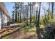 A partially shaded backyard features mature trees and access to a deck from the home at 2014 Poplar Rdg, Lawrenceville, GA 30044