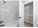 A tile surround bathtub in a bathroom provides a luxurious experience at 2014 Poplar Rdg, Lawrenceville, GA 30044