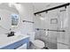 Stylish bathroom features blue vanity, a walk-in shower with glass doors, and tile surround at 2014 Poplar Rdg, Lawrenceville, GA 30044