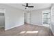 Bright bedroom features modern ceiling fan, light gray walls, and wood-look floors at 2014 Poplar Rdg, Lawrenceville, GA 30044