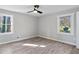 Cozy bedroom featuring two windows, wood-look floors, and neutral paint, creating a serene retreat at 2014 Poplar Rdg, Lawrenceville, GA 30044