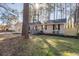 A well-maintained home featuring neutral siding, black shutters and inviting front yard with landscaped details at 2014 Poplar Rdg, Lawrenceville, GA 30044