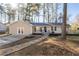 Charming single story home featuring light siding, black shutters, and a welcoming stone walkway and landscaped front yard at 2014 Poplar Rdg, Lawrenceville, GA 30044
