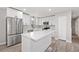 Bright kitchen features white cabinets, stainless steel appliances, and a large center island with white countertop at 2014 Poplar Rdg, Lawrenceville, GA 30044