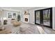 Inviting living room features a fireplace, hardwood floors, and access to an outdoor deck at 2014 Poplar Rdg, Lawrenceville, GA 30044