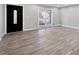 Bright living room features hardwood floors, a large window, and a contemporary front door at 2014 Poplar Rdg, Lawrenceville, GA 30044