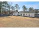 Expansive backyard showing the patio, lawn, fencing, and mature trees at 3285 Mitsy Forest Ne Way, Marietta, GA 30068
