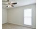 Bright bedroom featuring natural light, ceiling fan, and neutral carpet, offering a blank canvas for personalization at 3285 Mitsy Forest Ne Way, Marietta, GA 30068