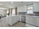 Modern kitchen featuring white cabinetry, sleek appliances, and an open layout to the dining room at 3285 Mitsy Forest Ne Way, Marietta, GA 30068