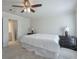 Well-lit main bedroom with plush carpet, side tables, and ceiling fan, conveniently located near bath at 3285 Mitsy Forest Ne Way, Marietta, GA 30068