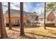 Exterior shot of a brick home with a large deck, lush yard, and mature trees at 418 Abbey Springs Way, Mcdonough, GA 30253