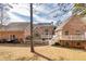 Back exterior view of a brick home, showcasing a spacious backyard, multi-level deck and manicured lawn at 418 Abbey Springs Way, Mcdonough, GA 30253
