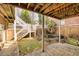 Backyard showcasing a pond feature and a brick exterior with wooden stairs leading to the upper level at 418 Abbey Springs Way, Mcdonough, GA 30253