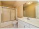 Neutral bathroom featuring a shower-tub combo, toilet, and white vanity at 418 Abbey Springs Way, Mcdonough, GA 30253