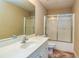 Bathroom featuring a shower-tub combo, toilet, and white vanity at 418 Abbey Springs Way, Mcdonough, GA 30253