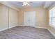 Bedroom with light walls, gray laminate flooring, a window, and a closet at 418 Abbey Springs Way, Mcdonough, GA 30253