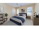 A cozy bedroom features plush carpeting, a comfortable bed, and natural light from two windows at 418 Abbey Springs Way, Mcdonough, GA 30253