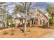 Attractive brick home with a circular driveway and manicured lawn, showcasing elegant design and curb appeal at 418 Abbey Springs Way, Mcdonough, GA 30253