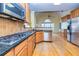Gourmet kitchen features tile backsplash, stainless appliances, hardwood floors, and abundant cabinets at 418 Abbey Springs Way, Mcdonough, GA 30253