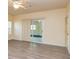 Bright living room featuring wood floors, ceiling fan, and sliding glass doors providing natural light at 418 Abbey Springs Way, Mcdonough, GA 30253
