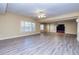 Spacious living room featuring laminate floors and a ceiling fan at 418 Abbey Springs Way, Mcdonough, GA 30253