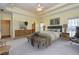 The primary bedroom features a tray ceiling, soft carpet, a neutral color scheme and a view to the bath at 418 Abbey Springs Way, Mcdonough, GA 30253