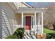 Welcoming front porch with white columns and a red front door, creating a charming entrance at 4628 Rolling Brook Ct, Union City, GA 30291