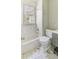 Bright bathroom with a classic white tub, gold fixtures, and elegant marble-patterned floor at 232 Westminster Ne Dr, Atlanta, GA 30309