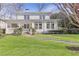 Charming two-story home featuring a brick facade, a well-manicured lawn, and mature trees, offers timeless appeal at 232 Westminster Ne Dr, Atlanta, GA 30309